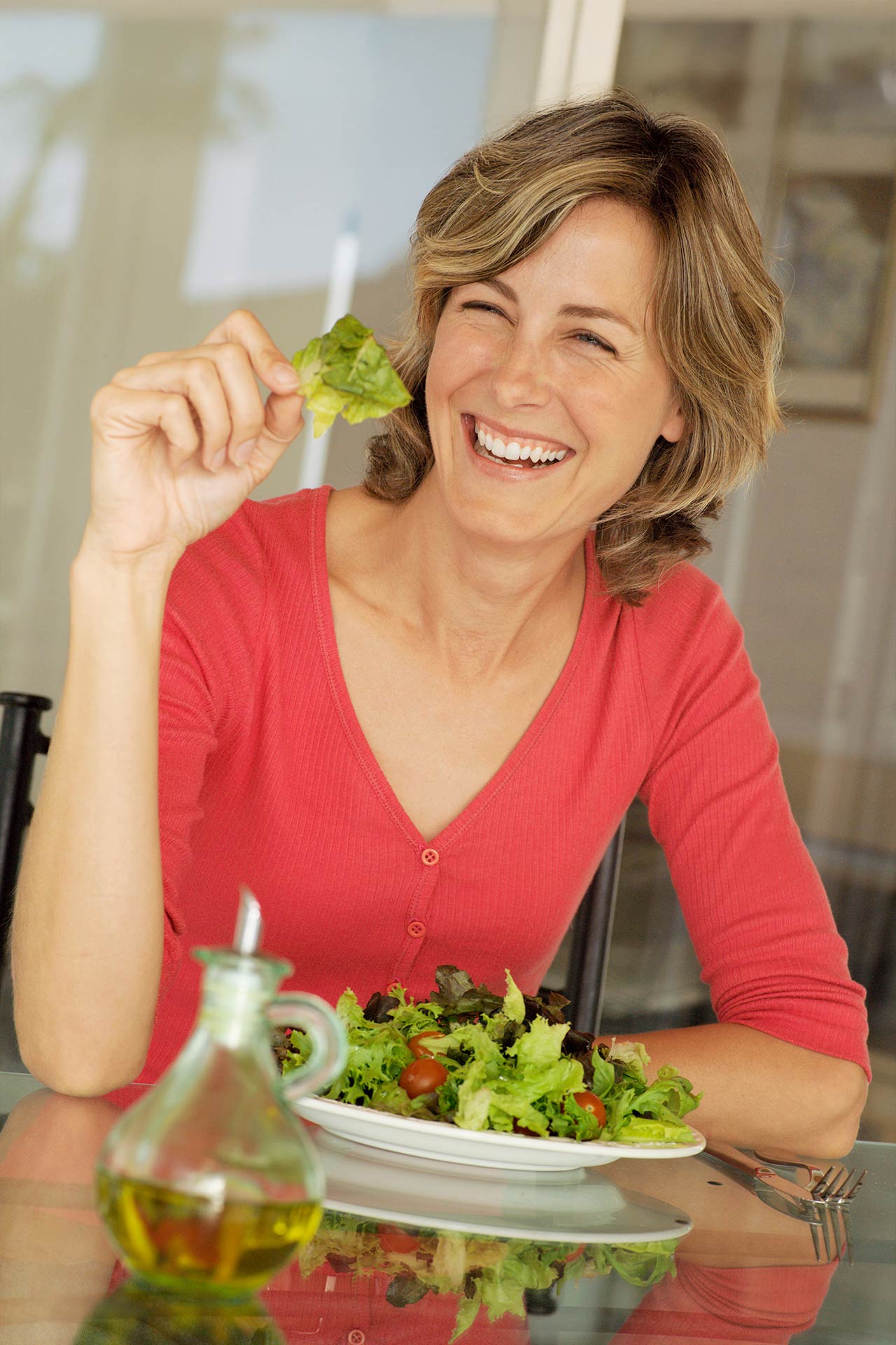 Happy woman enjoying salad