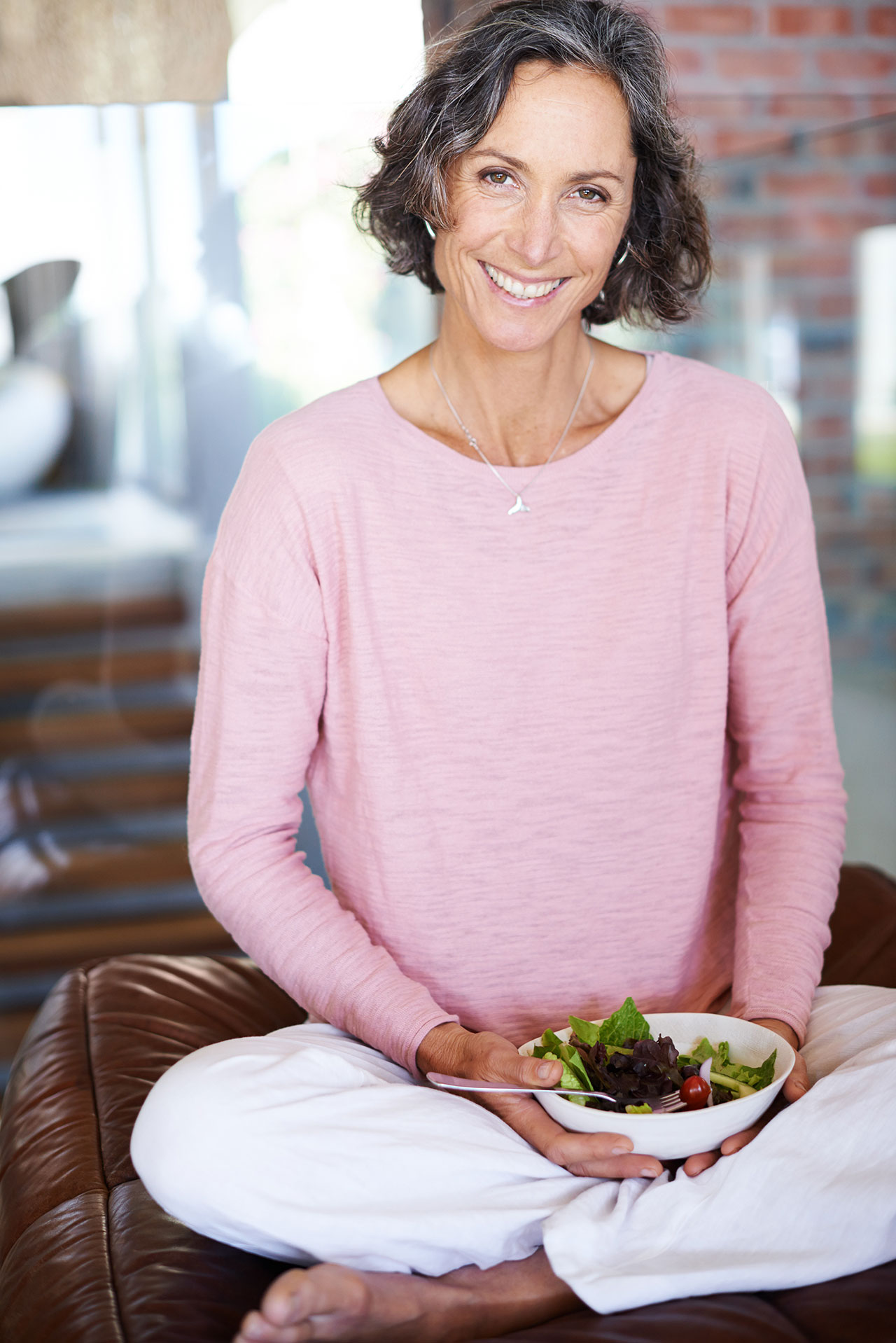 Healthy looking senior lady with salad