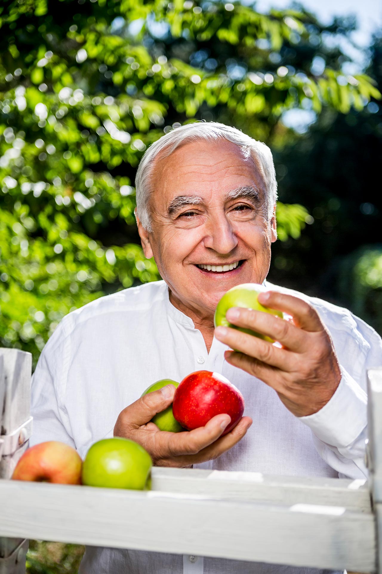 Senior man eating freshly picked fruit