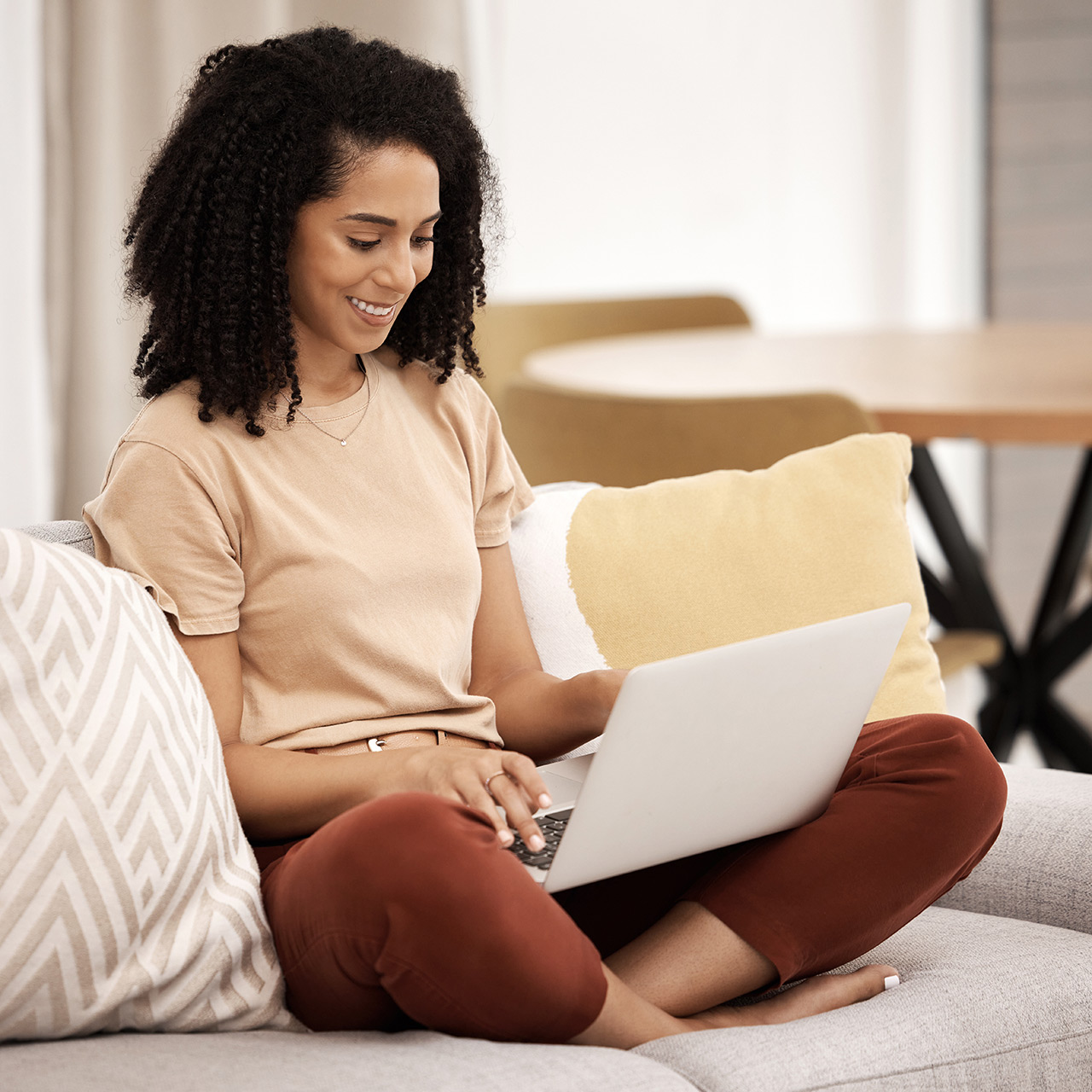 Woman relaxing on sofa with laptop